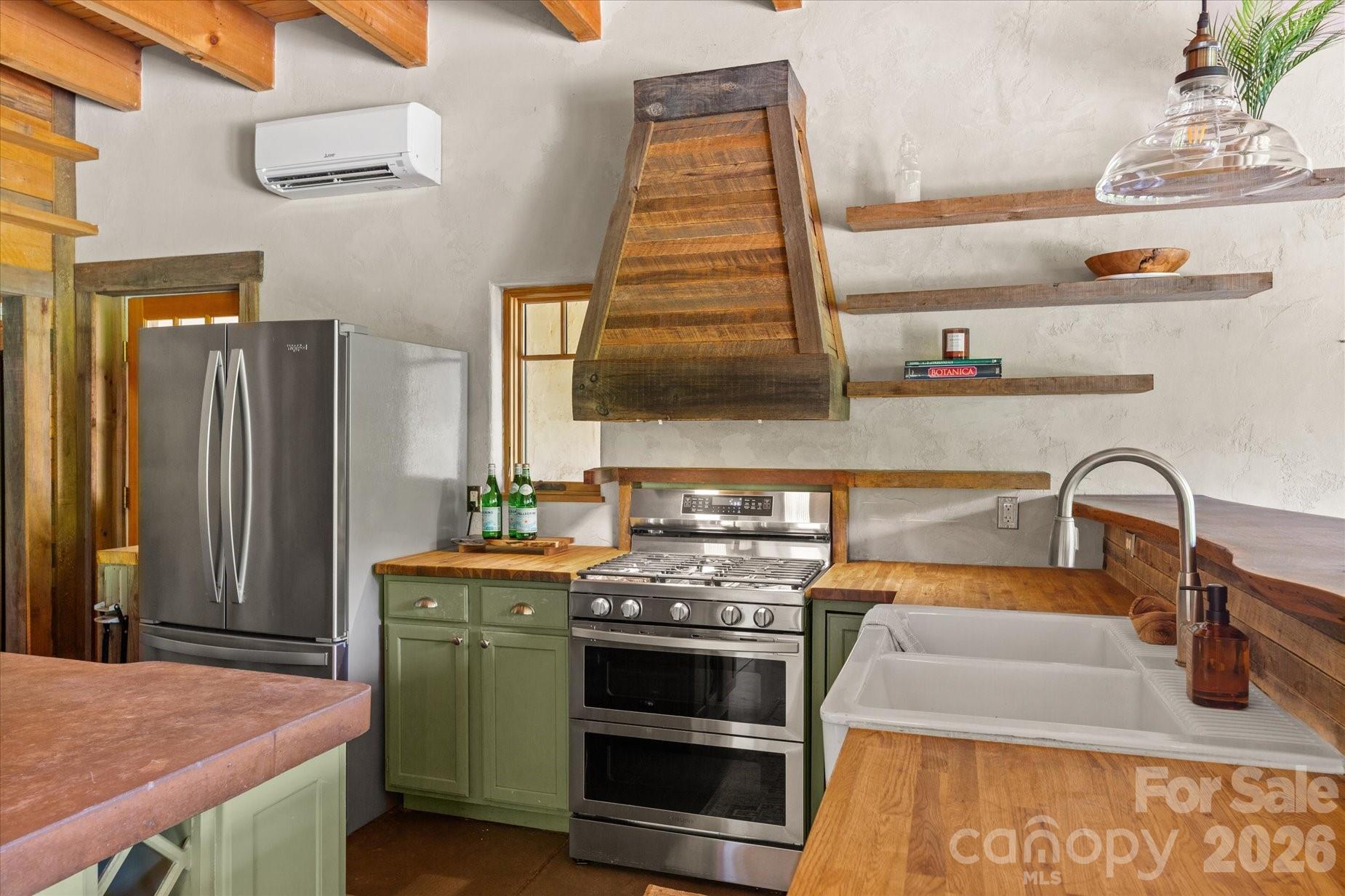 3151 Lumptown Road Marshall, NC 28753 - Photo 12 of 48 a kitchen with stainless steel appliances granite countertop a stove a sink and a refrigerator