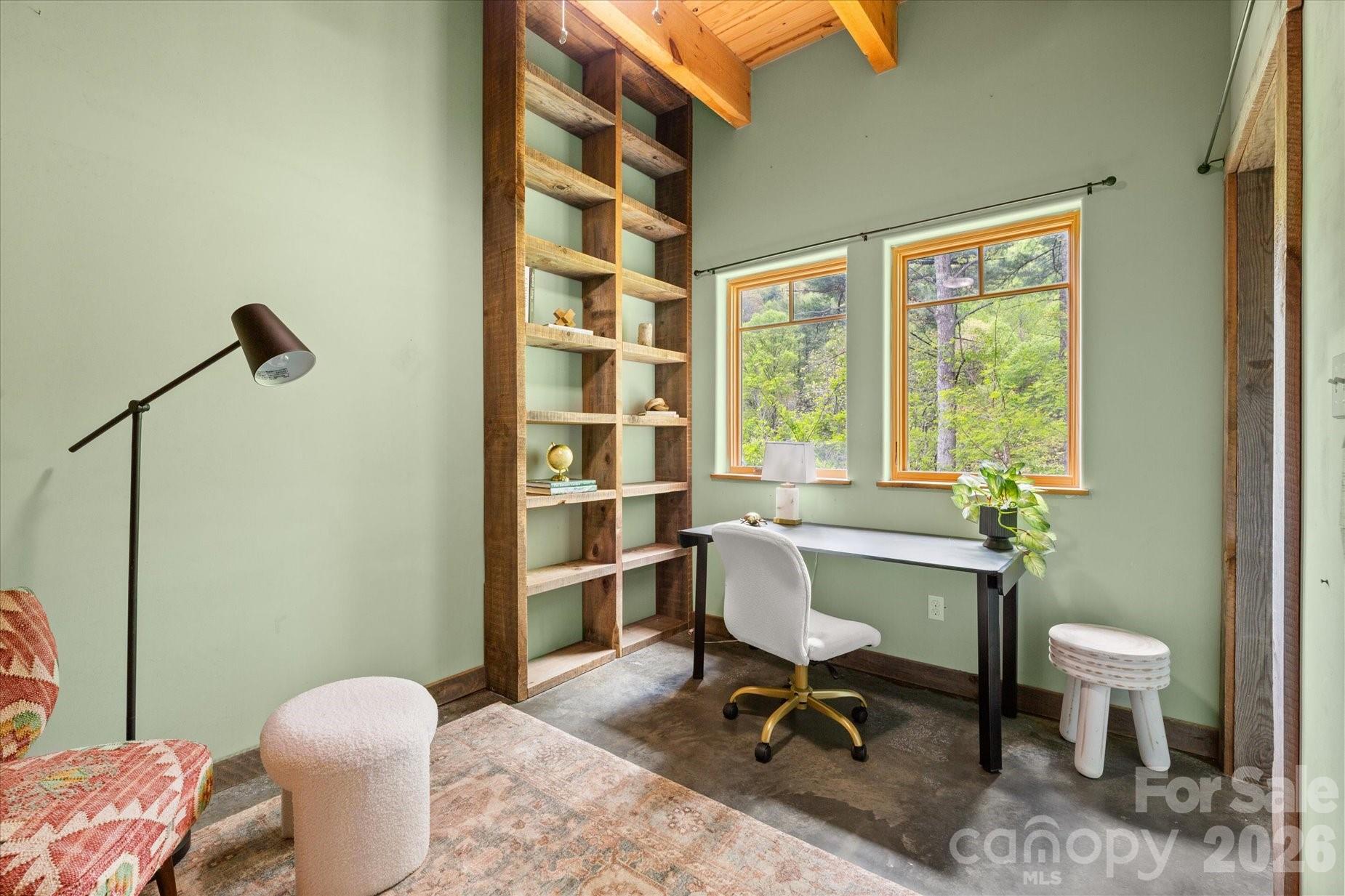 3151 Lumptown Road Marshall, NC 28753 - Photo 22 of 48 a view of a workspace with furniture and a window