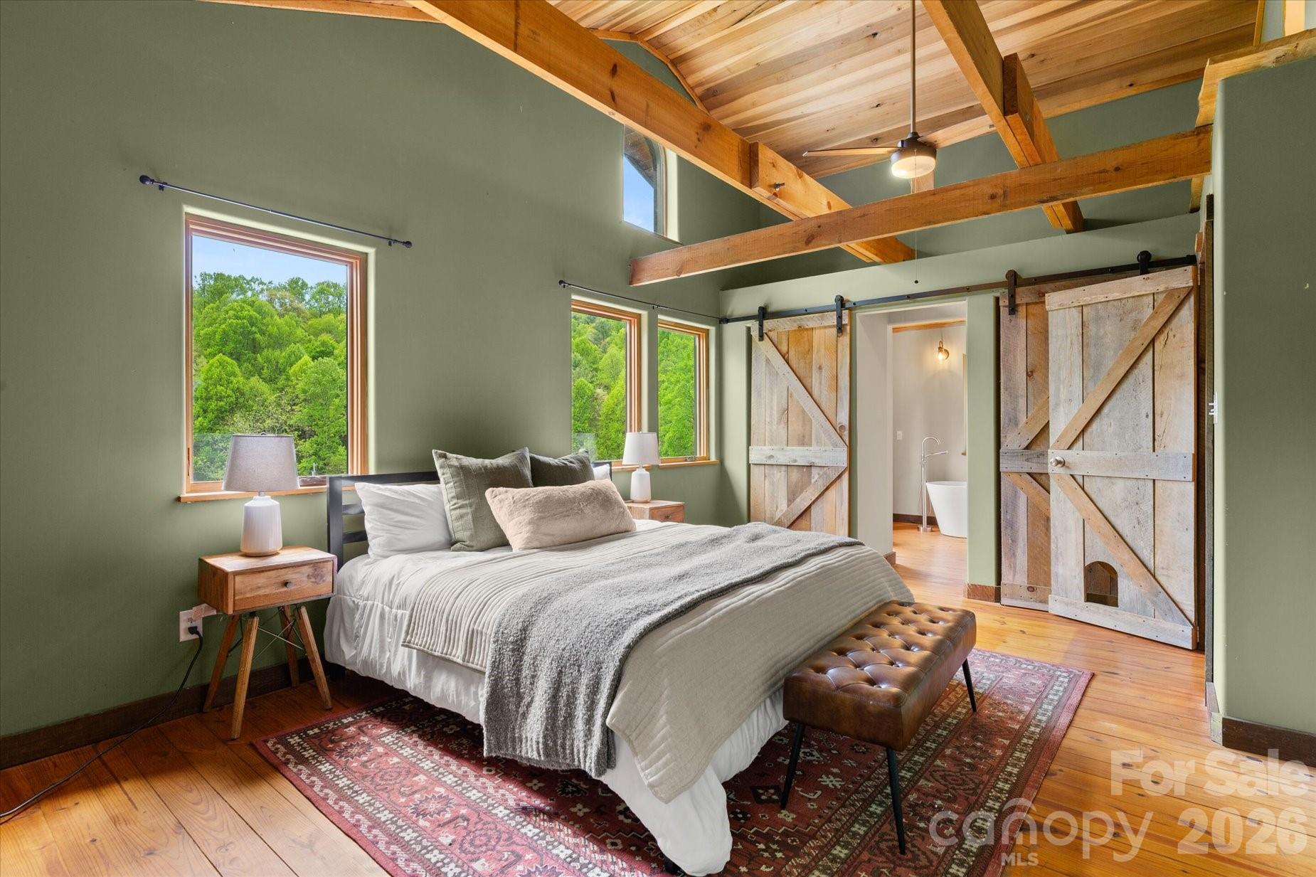 3151 Lumptown Road Marshall, NC 28753 - Photo 26 of 48 a bedroom with a bed a table and windows