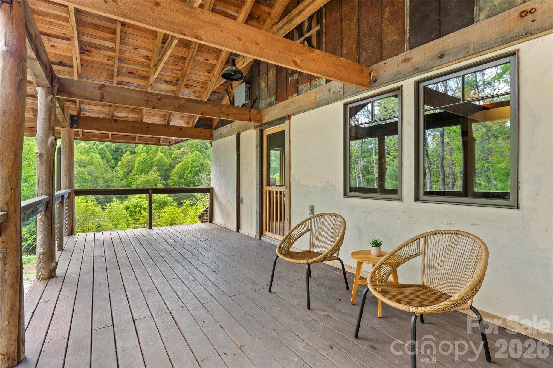 3151 Lumptown Road Marshall, NC 28753 - Photo 31 of 48 a view of a porch with furniture and wooden floor
