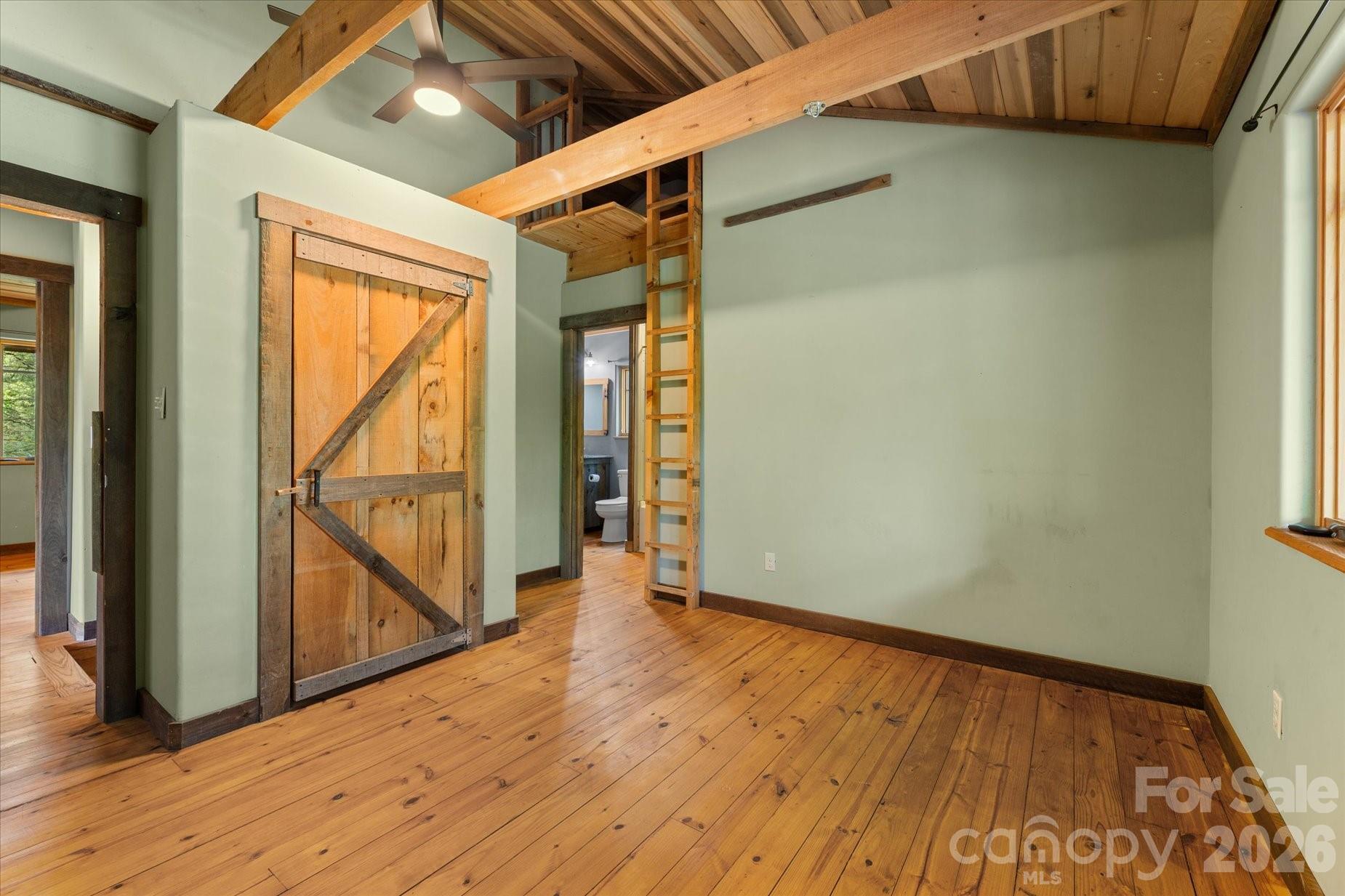 3151 Lumptown Road Marshall, NC 28753 - Photo 33 of 48 a view of an empty room with wooden floor and a window