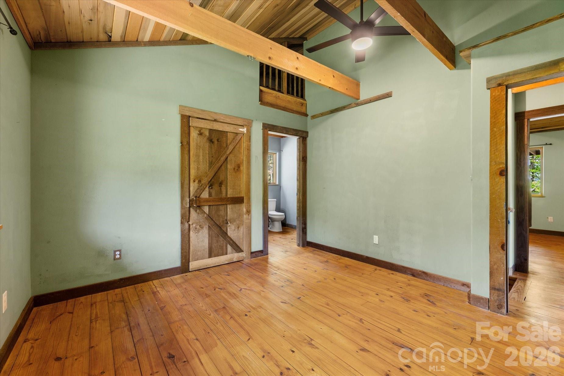 3151 Lumptown Road Marshall, NC 28753 - Photo 36 of 48 a view of an empty room with wooden floor and a window