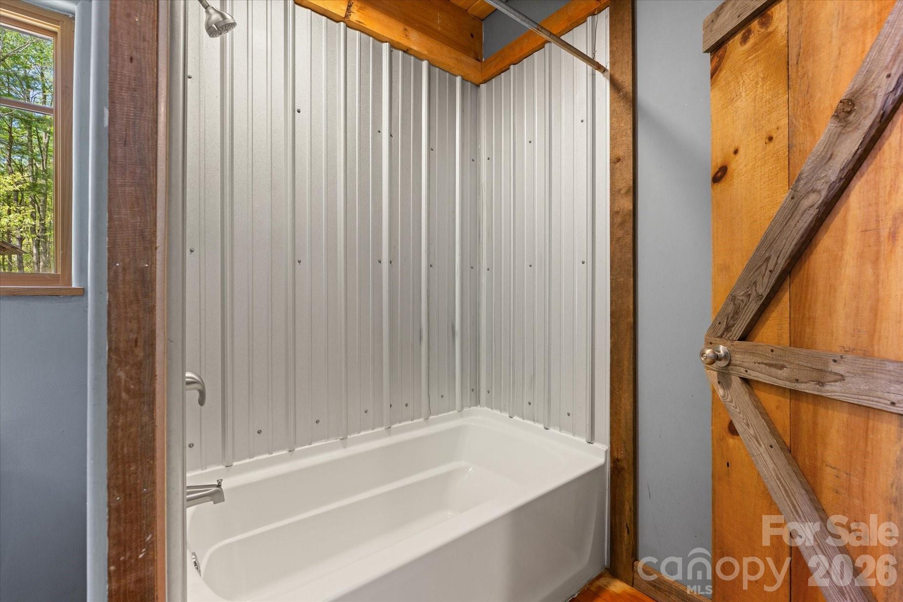 3151 Lumptown Road Marshall, NC 28753 - Photo 38 of 48 a bathroom with a tub and shower