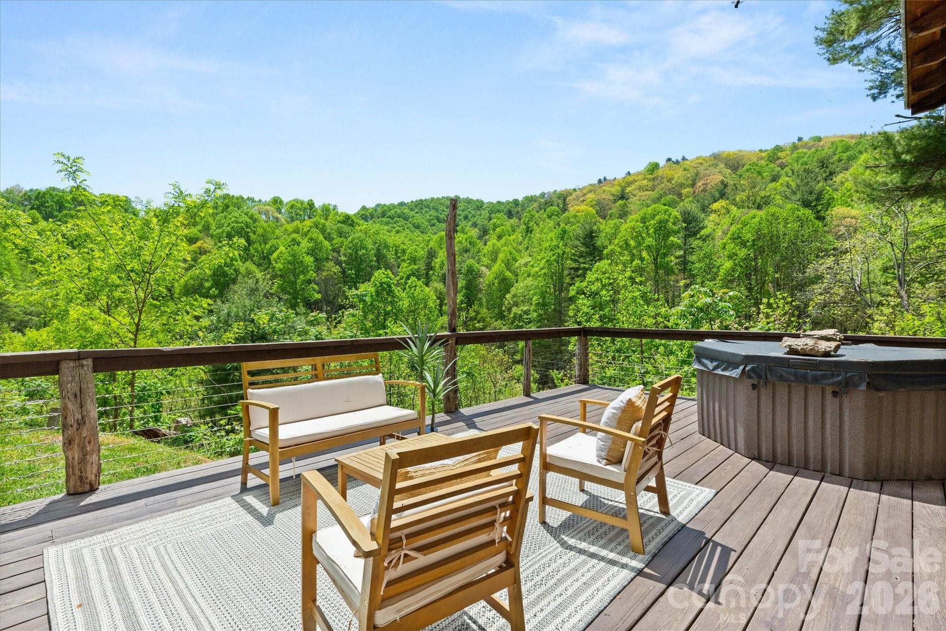3151 Lumptown Road Marshall, NC 28753 - Photo 4 of 48 a view of a balcony with wooden floor and outdoor seating