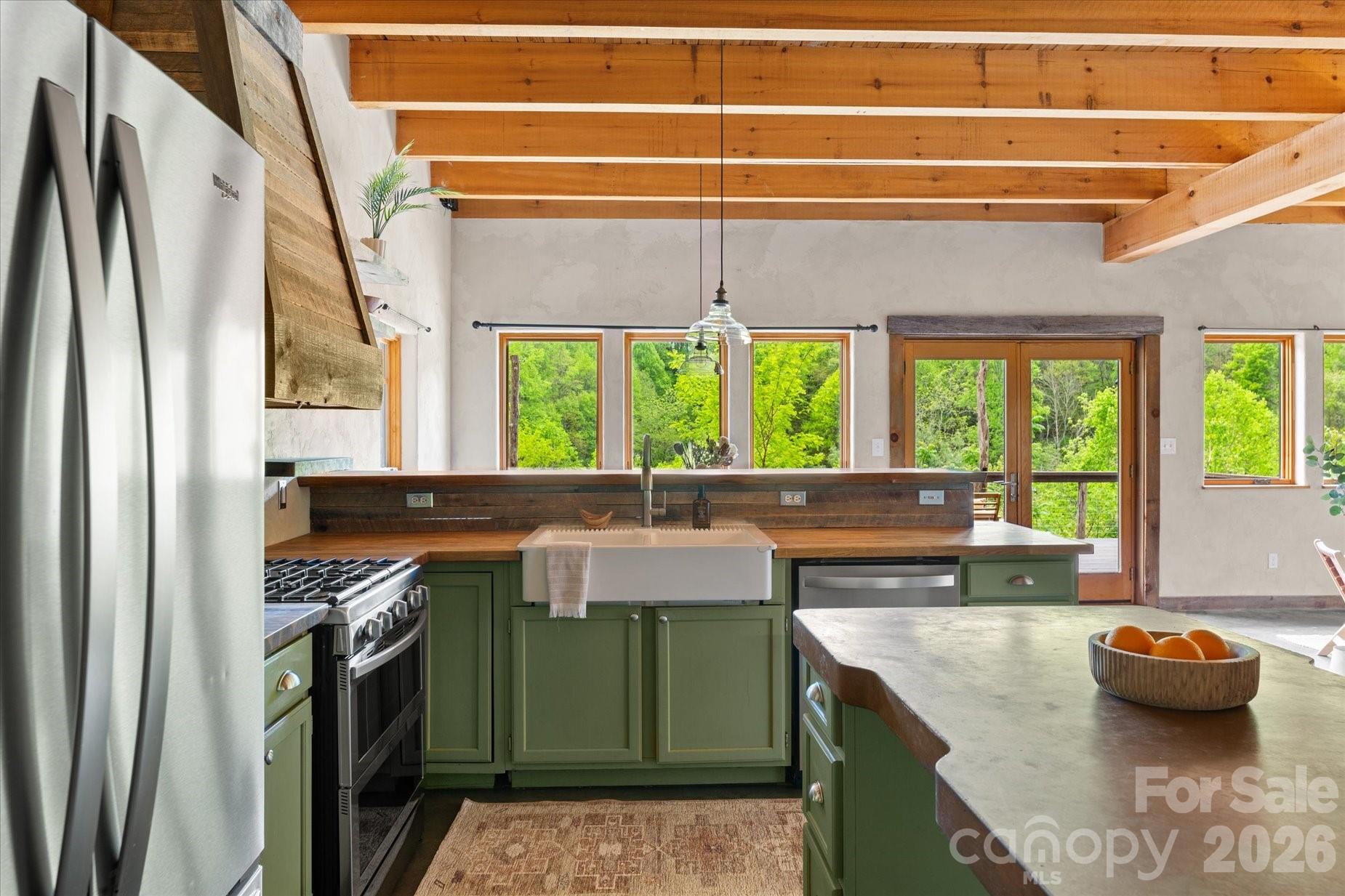 3151 Lumptown Road Marshall, NC 28753 - Photo 8 of 48 a kitchen with a large window and cabinets
