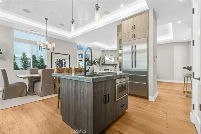 a large kitchen with a table and chairs in it