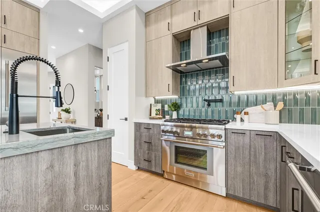 a kitchen with granite countertop a refrigerator and a stove top oven