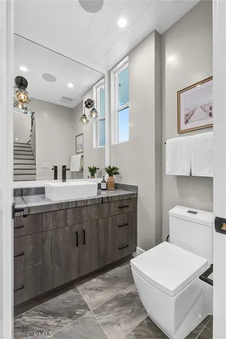a kitchen with kitchen island granite countertop a stove a sink and a cabinets