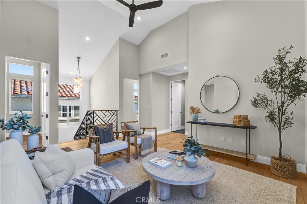 2016 Farrell Avenue, Unit A Redondo Beach, CA 90278 - Photo 19 of 42 a living room with furniture a mirror and a chandelier