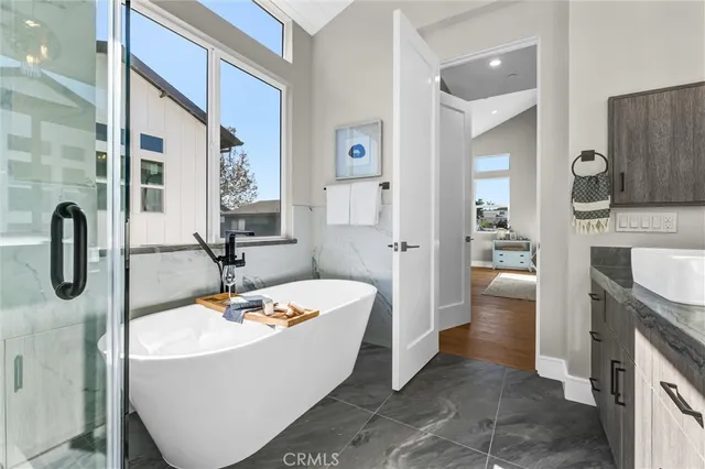 a bathroom with a tub sink and mirror