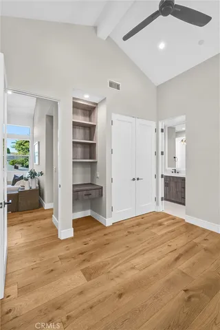 a view of empty room with wooden floor and cabinet