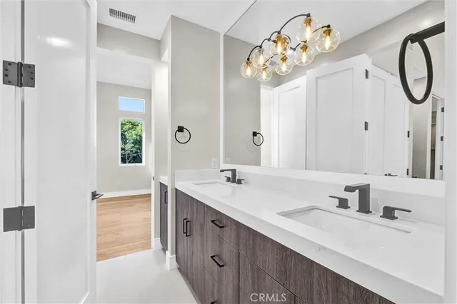 a bathroom with a sink vanity and a mirror