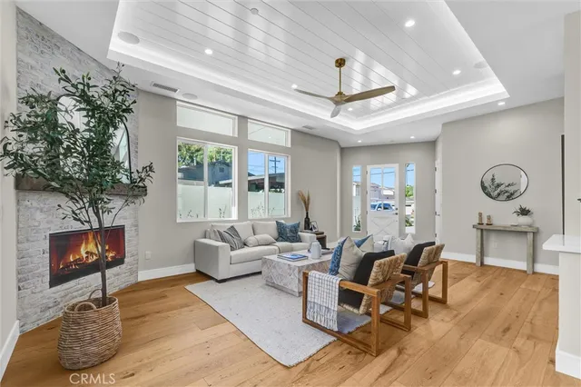 a living room with fireplace furniture and a large window