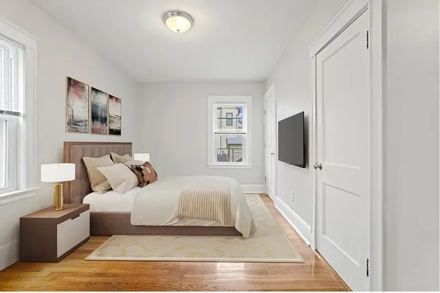 a bedroom with a bed and a television