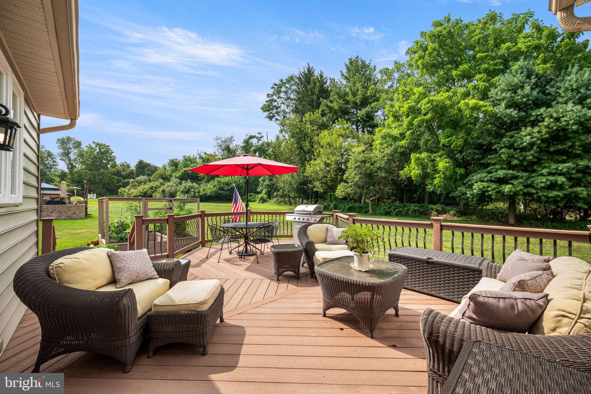 103 Riverside Lane Coatesville, PA 19320 - Photo 40 of 52 Serene deck with lush green backdrop.