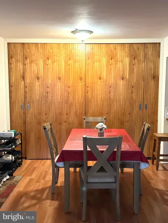 a view of a a dining room with furniture window and wooden floor