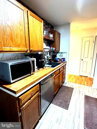 a kitchen with stainless steel appliances a sink a stove and a microwave