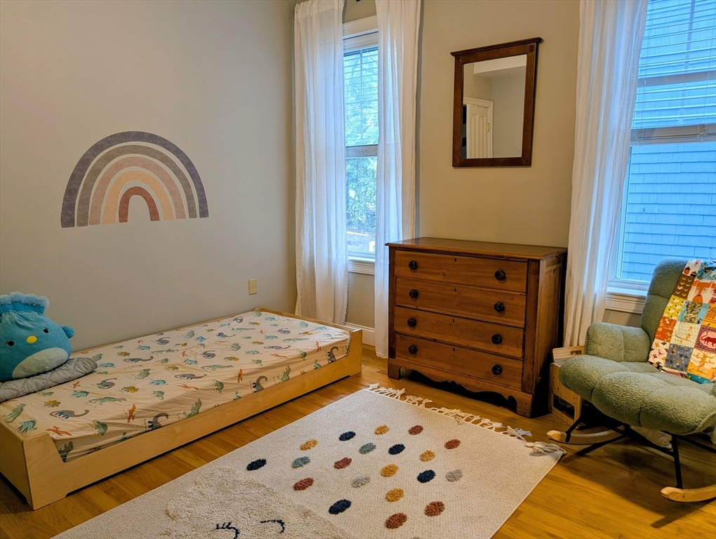 17 Lafield Street, Unit 1 Boston, MA 02122 - Photo 6 of 19 a bedroom with a bed and a dresser