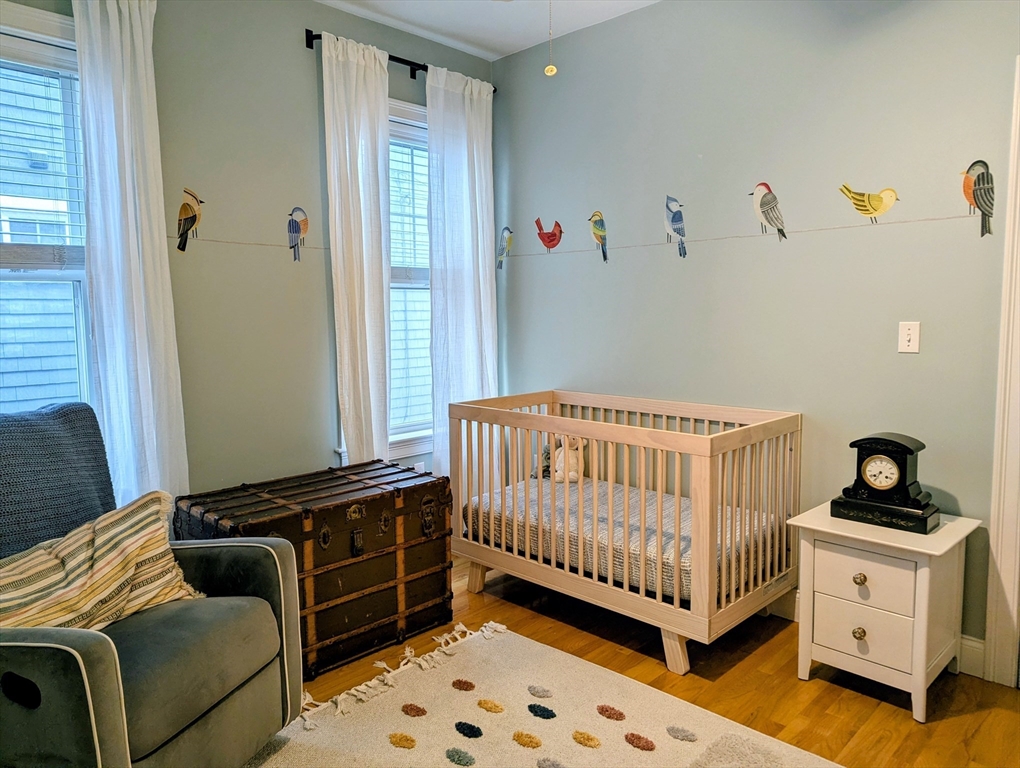 17 Lafield Street, Unit 1 Boston, MA 02122 - Photo 7 of 19 a bedroom with a bed and wooden floor