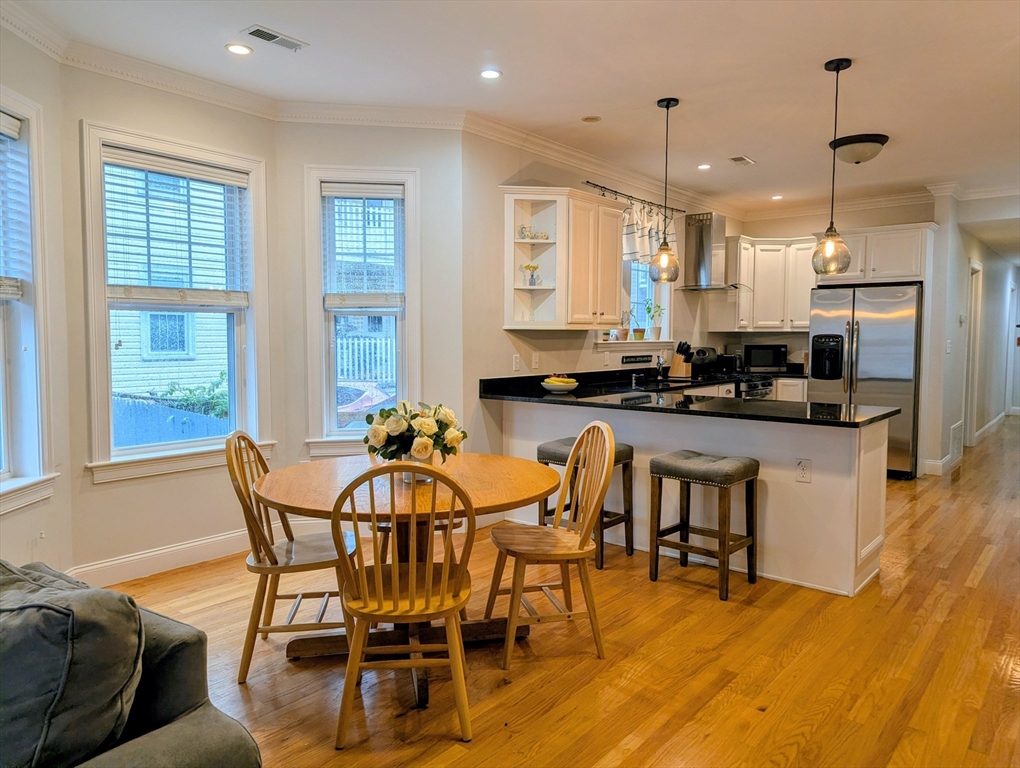 17 Lafield Street, Unit 1 Boston, MA 02122 - Photo 10 of 19 a view of a dining room with furniture and wooden floor