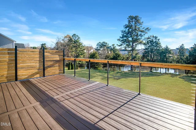 a view of a wooden deck with a lake view