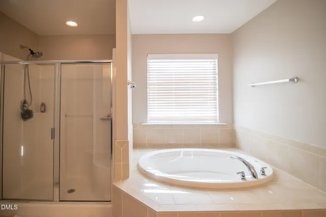 a bathroom with a bathtub and a shower
