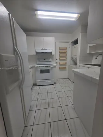 a view of an empty room and wooden floor