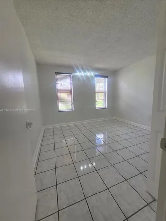 a view of empty room with windows