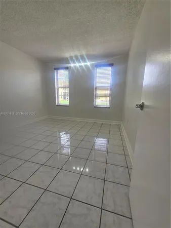 a bathroom with a granite countertop sink mirror and toilet