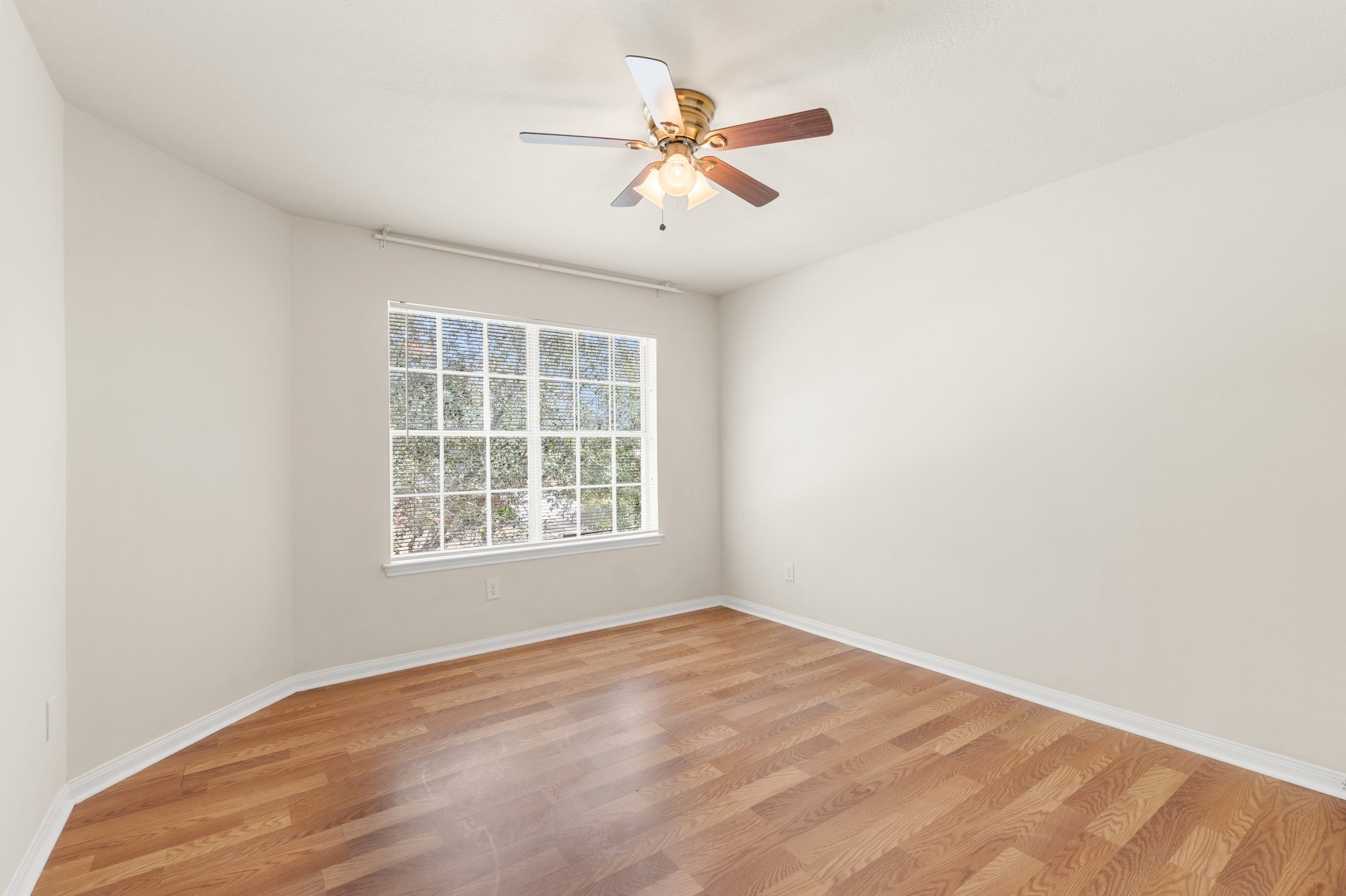 3111 Holly Ranch Drive Katy, TX 77494 - Photo 18 of 28 an empty room with wooden floor and windows