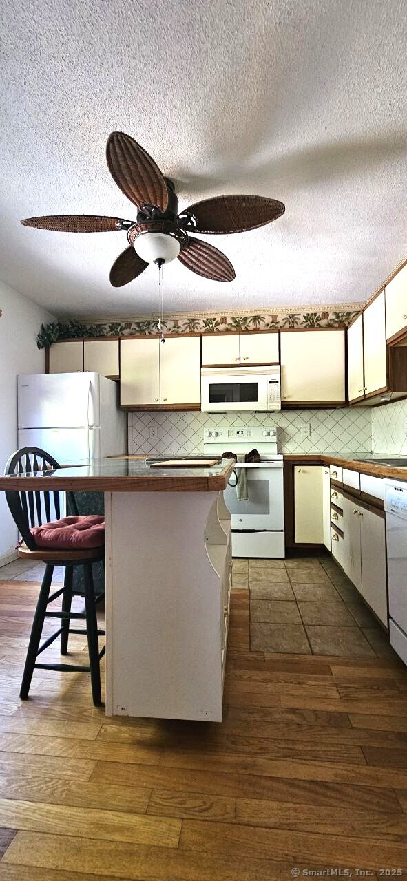 489 Wolcott Street, Unit 47 Bristol, CT 06010 - Photo 12 of 32 a kitchen with stainless steel appliances granite countertop a stove a sink and a refrigerator