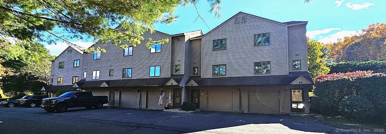 489 Wolcott Street, Unit 47 Bristol, CT 06010 - Photo 2 of 32 a view of a house with a patio and a yard