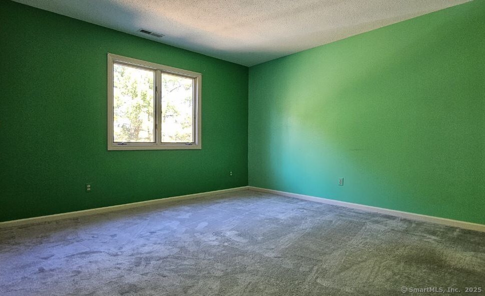 489 Wolcott Street, Unit 47 Bristol, CT 06010 - Photo 21 of 32 an empty room with windows