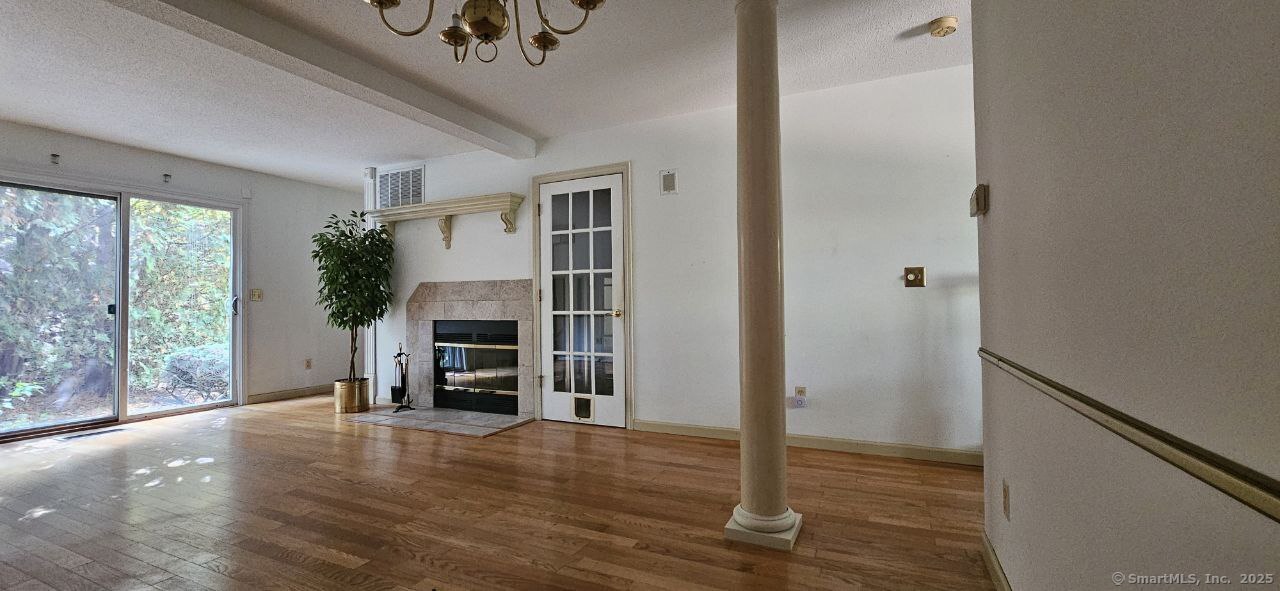 489 Wolcott Street, Unit 47 Bristol, CT 06010 - Photo 6 of 32 a view of a livingroom with a fireplace wooden floor and window