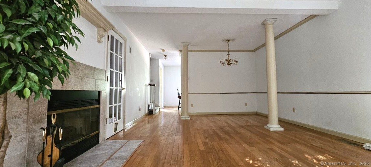 489 Wolcott Street, Unit 47 Bristol, CT 06010 - Photo 7 of 32 a view of a hallway with wooden floor and staircase