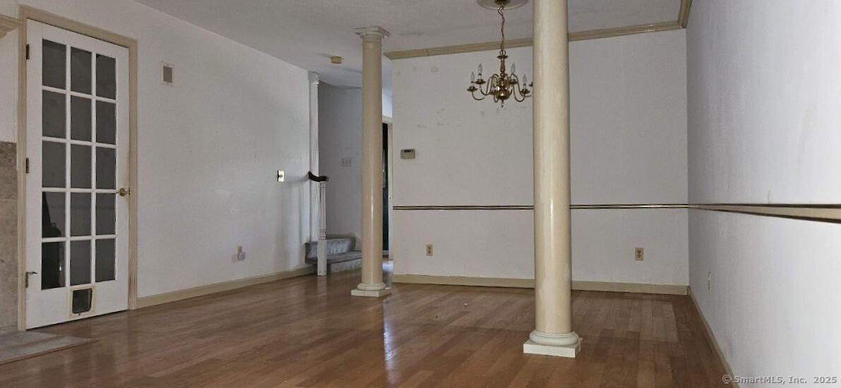 489 Wolcott Street, Unit 47 Bristol, CT 06010 - Photo 10 of 32 a view of empty room with wooden floor