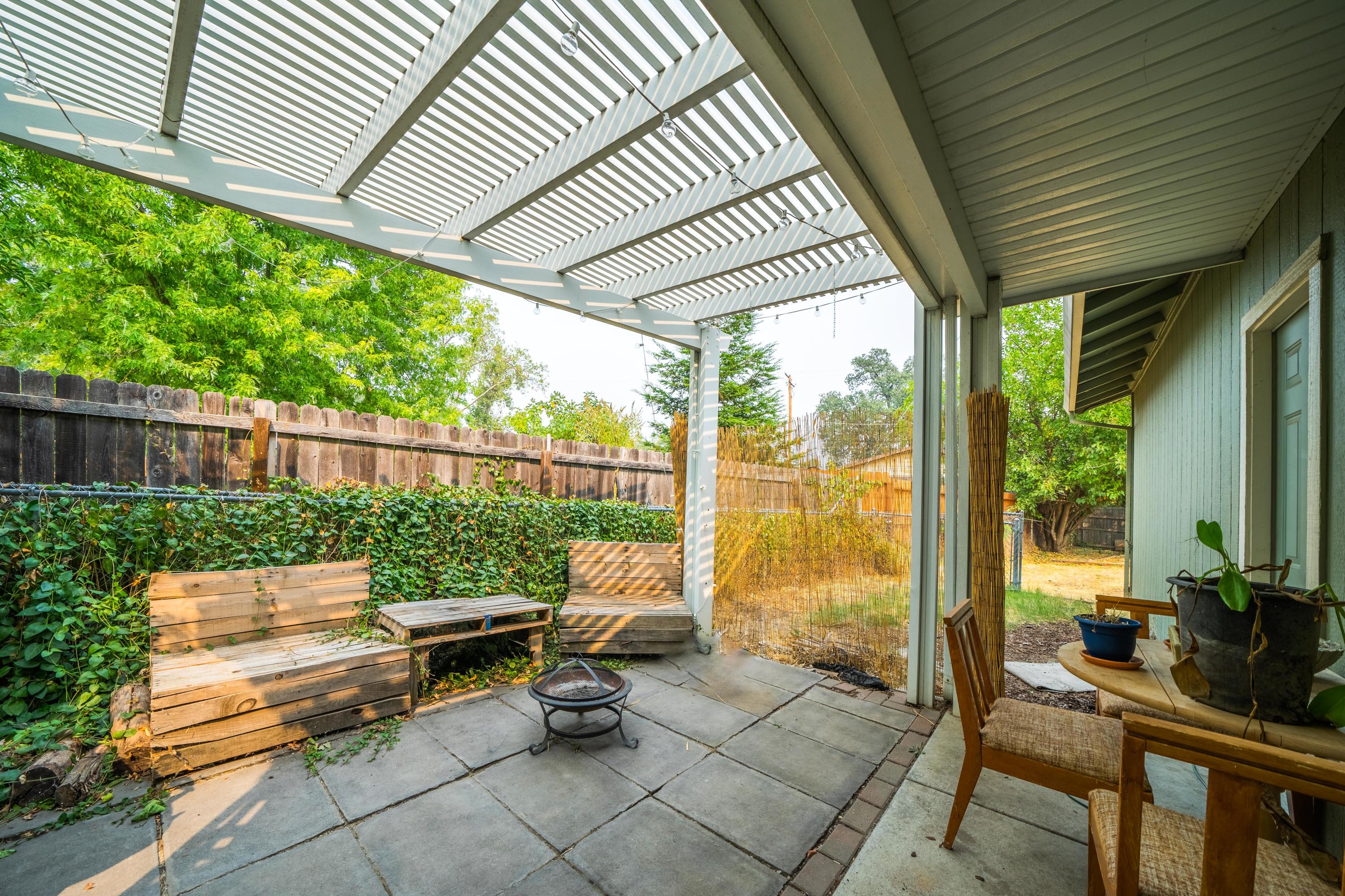 5484 Cedars Road Redding, CA 96001 - Photo 4 of 11 a roof deck with outdoor seating and trees