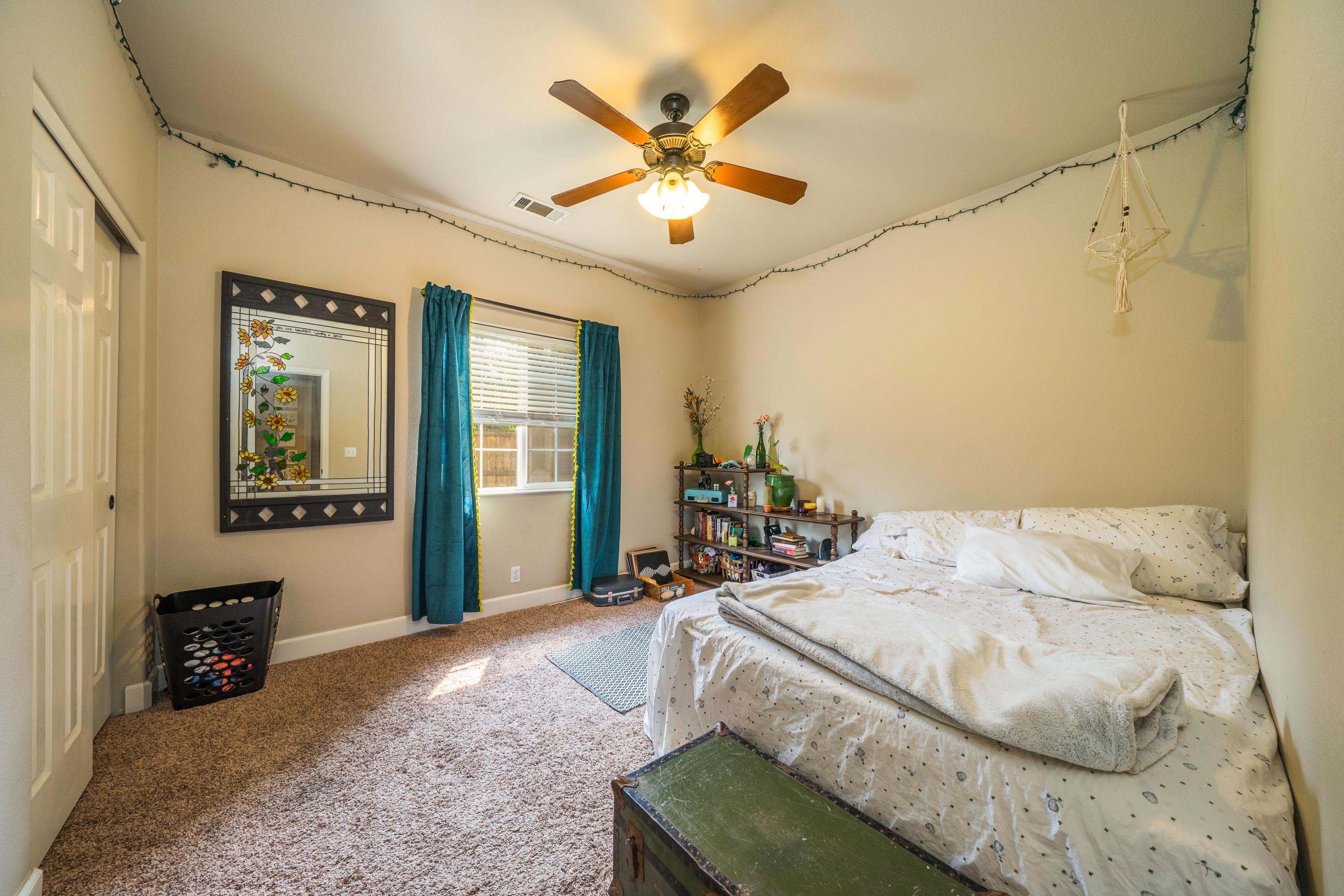 5484 Cedars Road Redding, CA 96001 - Photo 7 of 11 a bedroom with a bed and ceiling fan