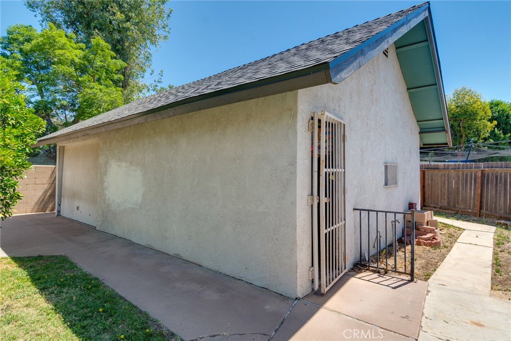 9130 Duncan Avenue Riverside, CA 92503 - Photo 30 of 34 a side view of a house with wooden fence
