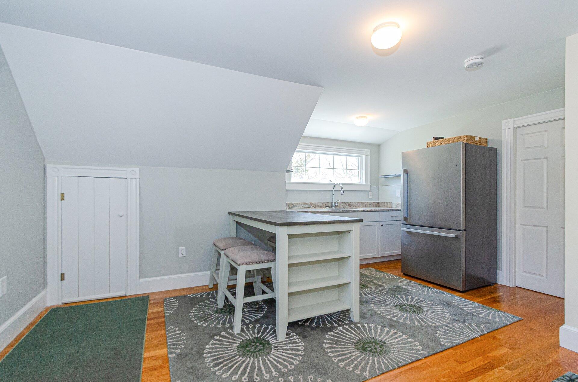 1089 Main Street Cotuit, MA 02635 - Photo 28 of 41 a kitchen with a wooden floor and a refrigerator