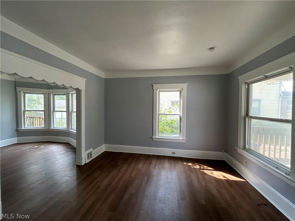 3403 Fulton Road, Unit DOWN Cleveland, OH 44109 - Photo 4 of 18 Spare room featuring dark wood-type flooring