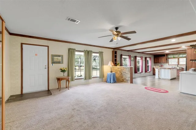 a living room with furniture and a ceiling fan