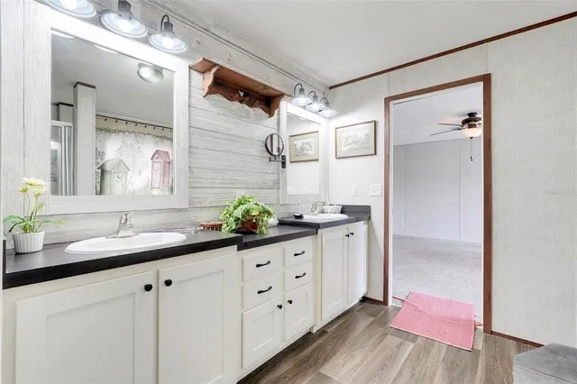 a bathroom with a double vanity sink and a mirror