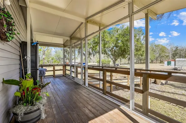 a view of a balcony with lake view and wooden floor