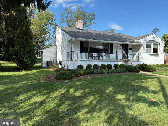 a front view of a house with a garden and porch