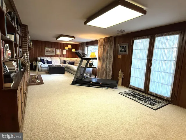 a view of a living room with furniture and window