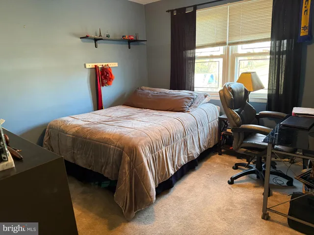 a bedroom with bed and a window