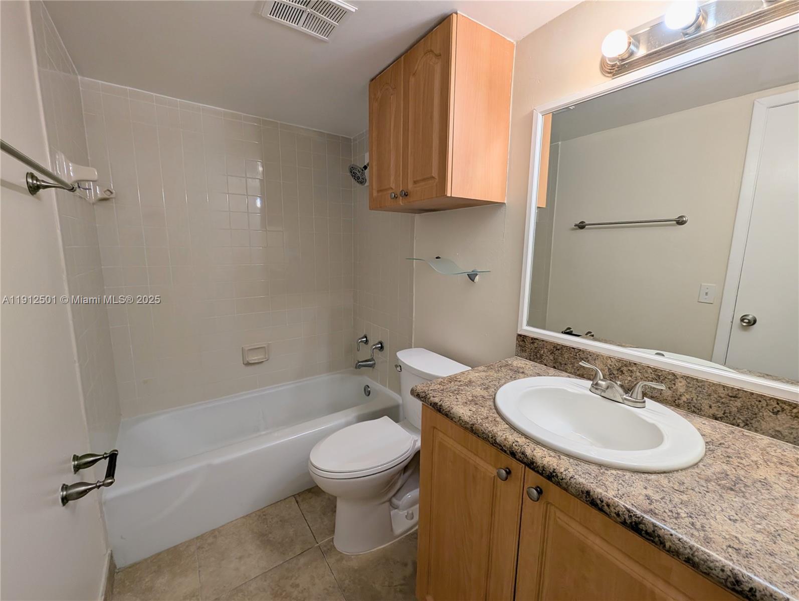 7230 Fairway Drive, Unit F4 Miami Lakes, FL 33014 - Photo 11 of 22 a bathroom with a granite countertop sink toilet and shower