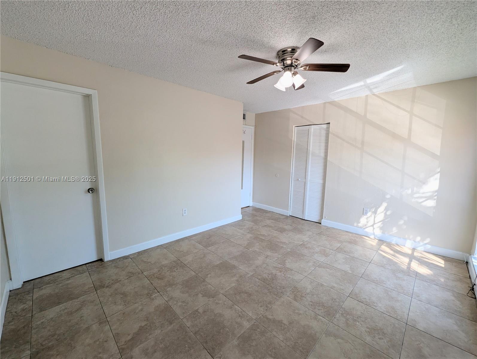 7230 Fairway Drive, Unit F4 Miami Lakes, FL 33014 - Photo 13 of 22 a view of an empty room with a chandelier fan