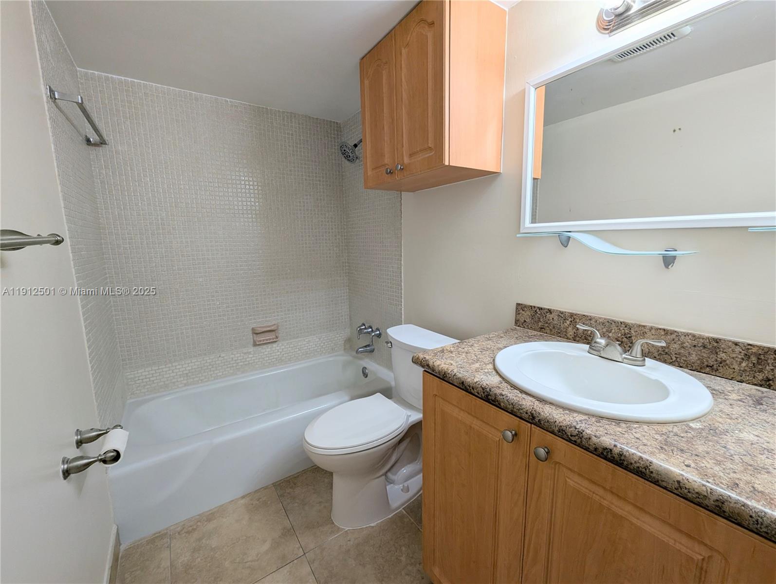 7230 Fairway Drive, Unit F4 Miami Lakes, FL 33014 - Photo 15 of 22 a bathroom with a granite countertop sink toilet mirror and bathtub